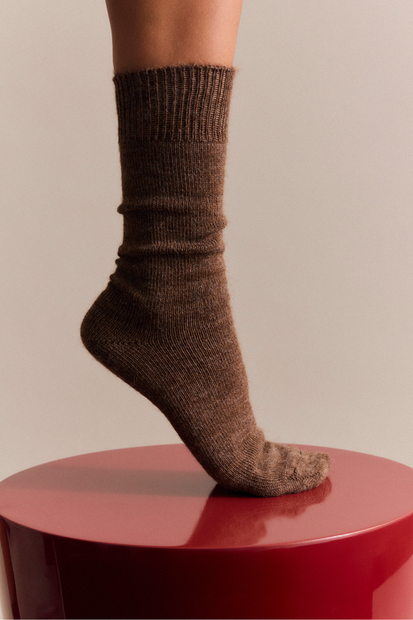 Person wearing a treacle brown alpaca sock
