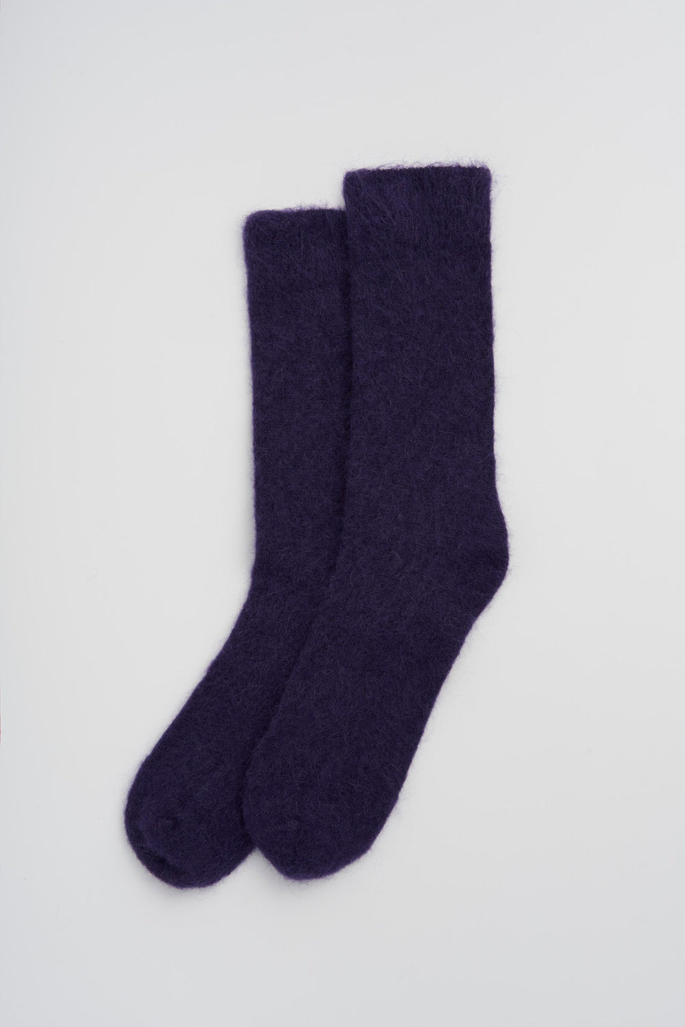 Pair of purple ultra soft alpaca socks on a light gray background