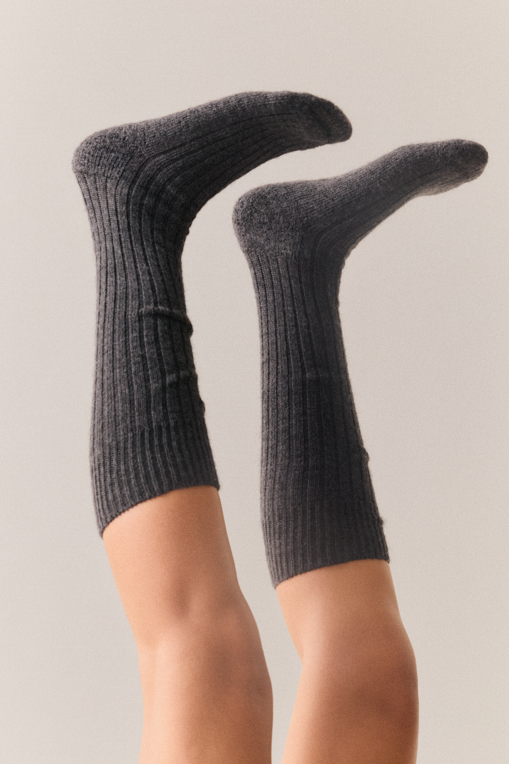 Legs wearing grey wool knee high socks