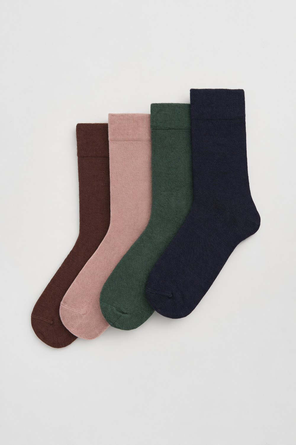 Four bamboo socks making up the Everyday Collection in brown, peach, green and blue.