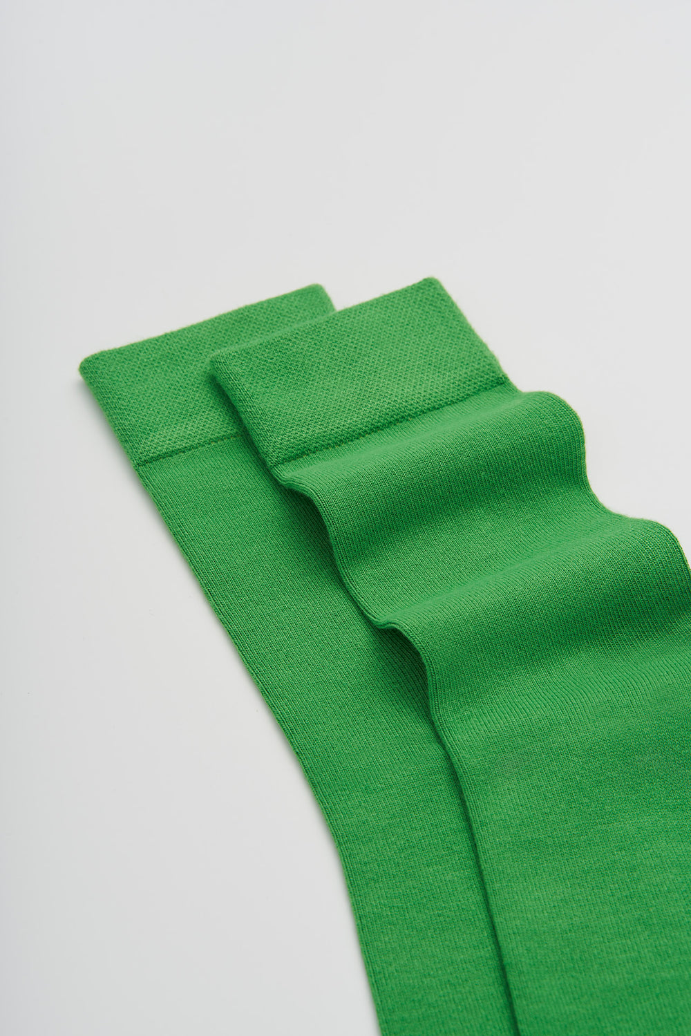 Green bamboo socks on a light grey background