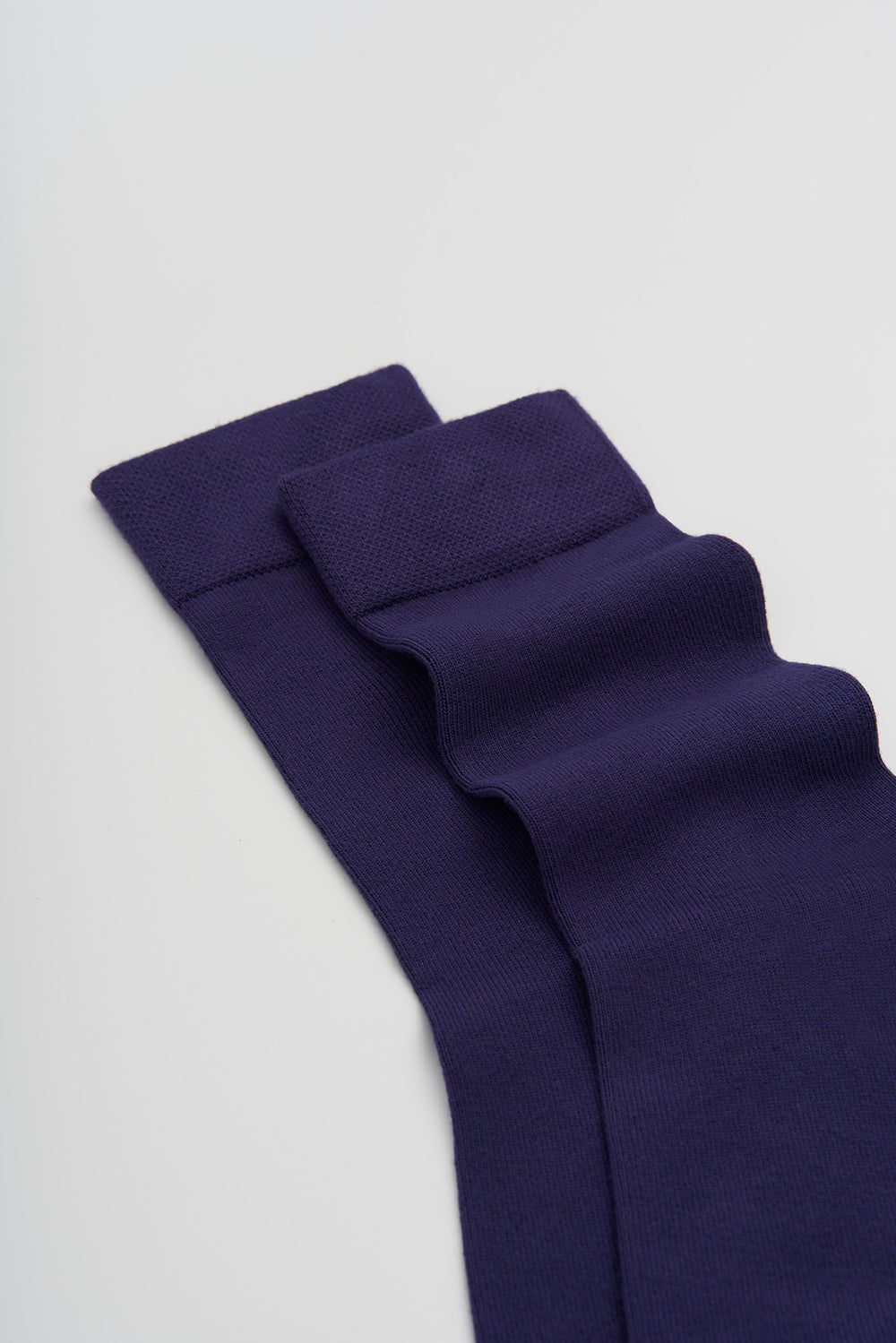 Indigo bamboo socks on a light grey background