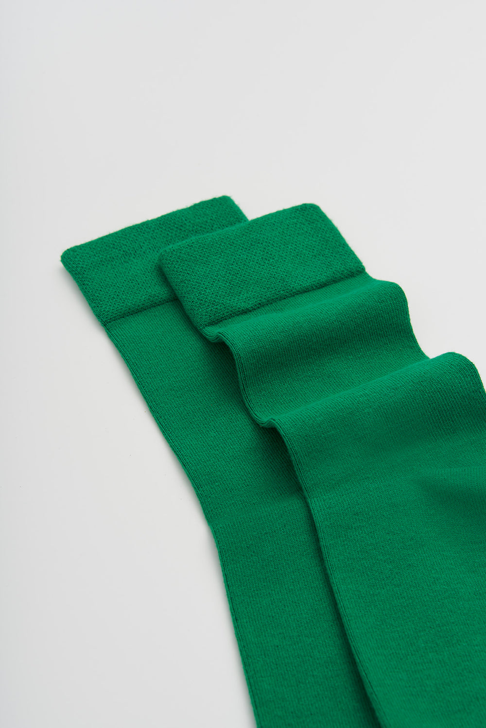 Green bamboo socks on a light grey background