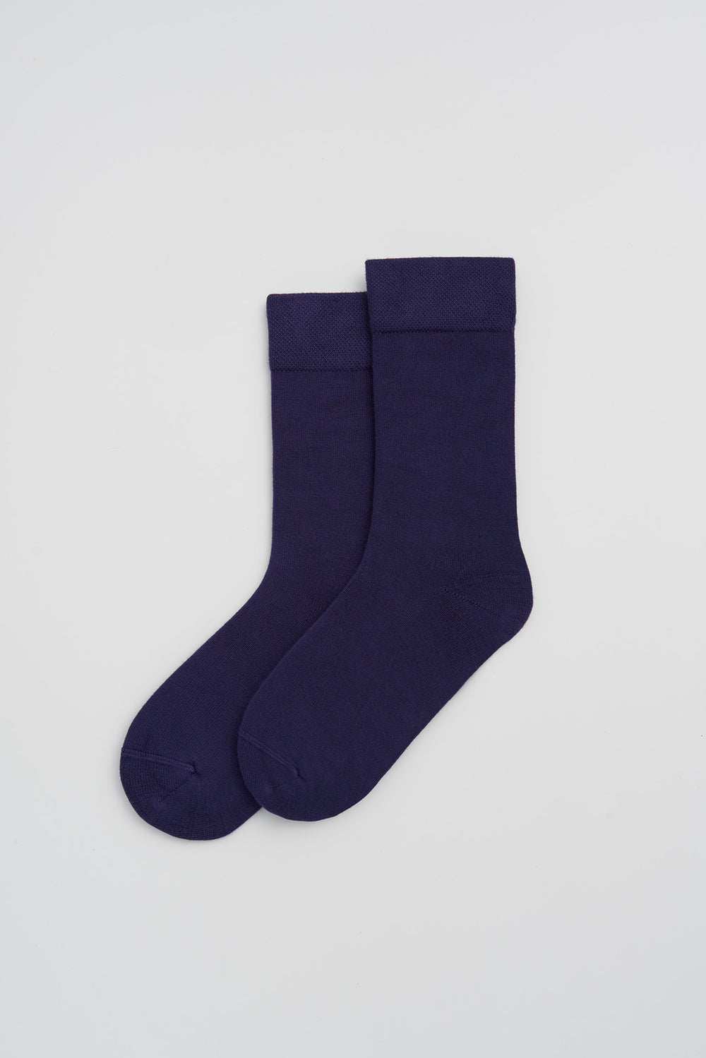Pair of indigo bamboo socks on a light grey background