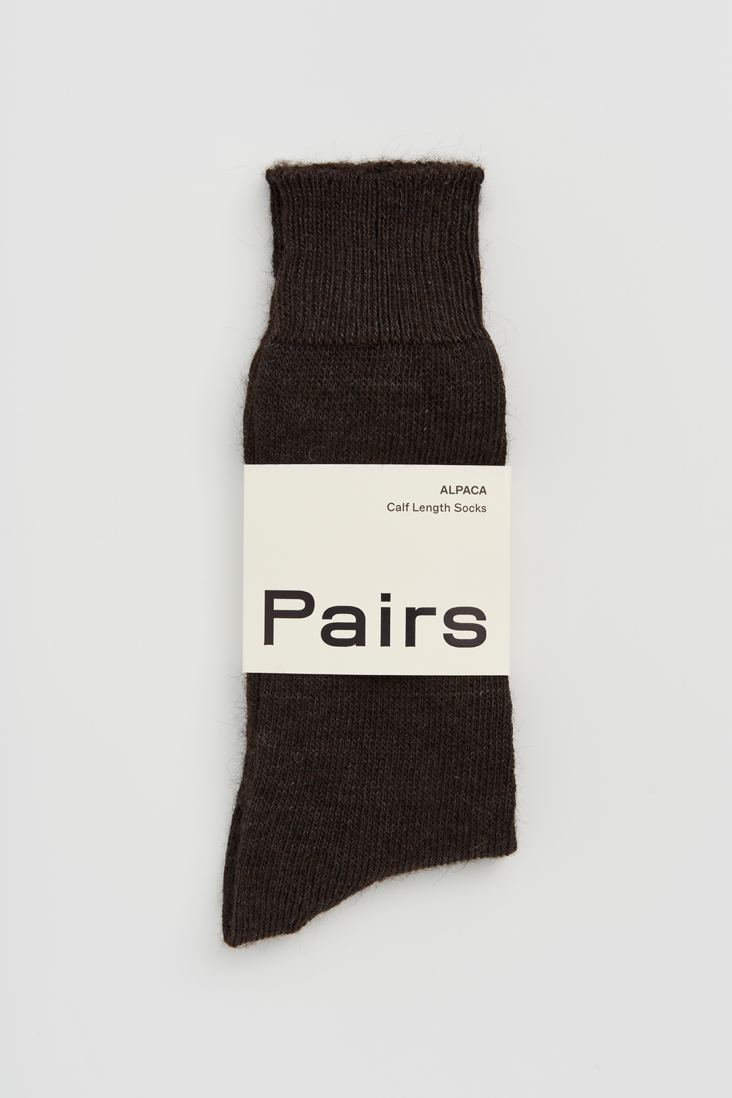 Dark brown calf-length alpaca sock with 'Pairs' packaging band on a white background