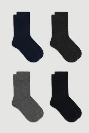 Four pairs of calf length bamboo socks in black, dark gray, navy blue and a lighter grey on a white background