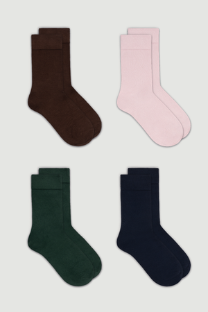 Four pairs of calf length bamboo socks in brown, pink, green, and navy on a white background