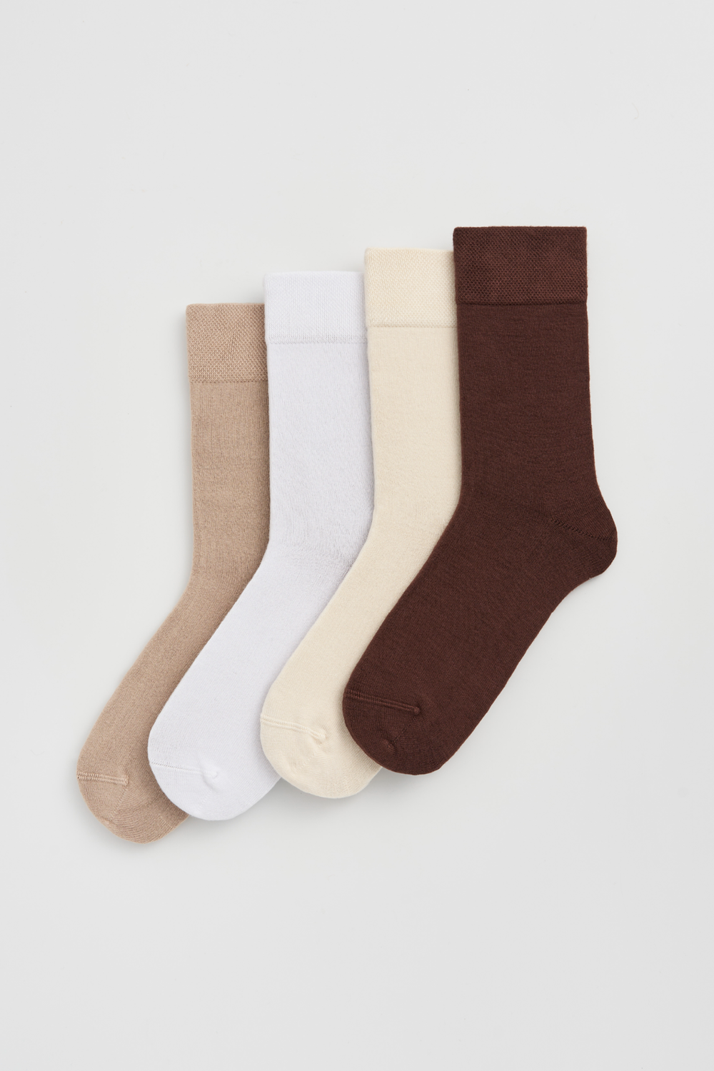 Four pairs of calf-length bamboo socks in beige, white, cream and brown on a light grey background