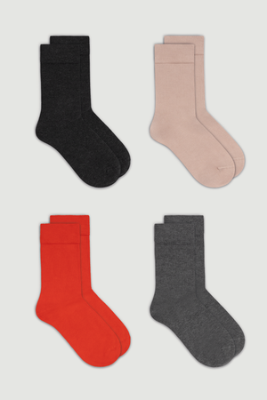 Four pairs of calf length bamboo sock in dark grey, pink, red, and grey on a white background
