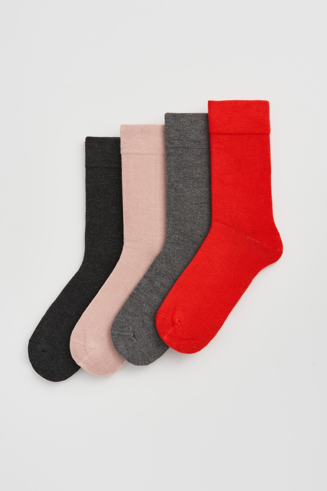 Four pairs of calf-length bamboo socks in charcoal grey, pink, grey, and red on a light grey background