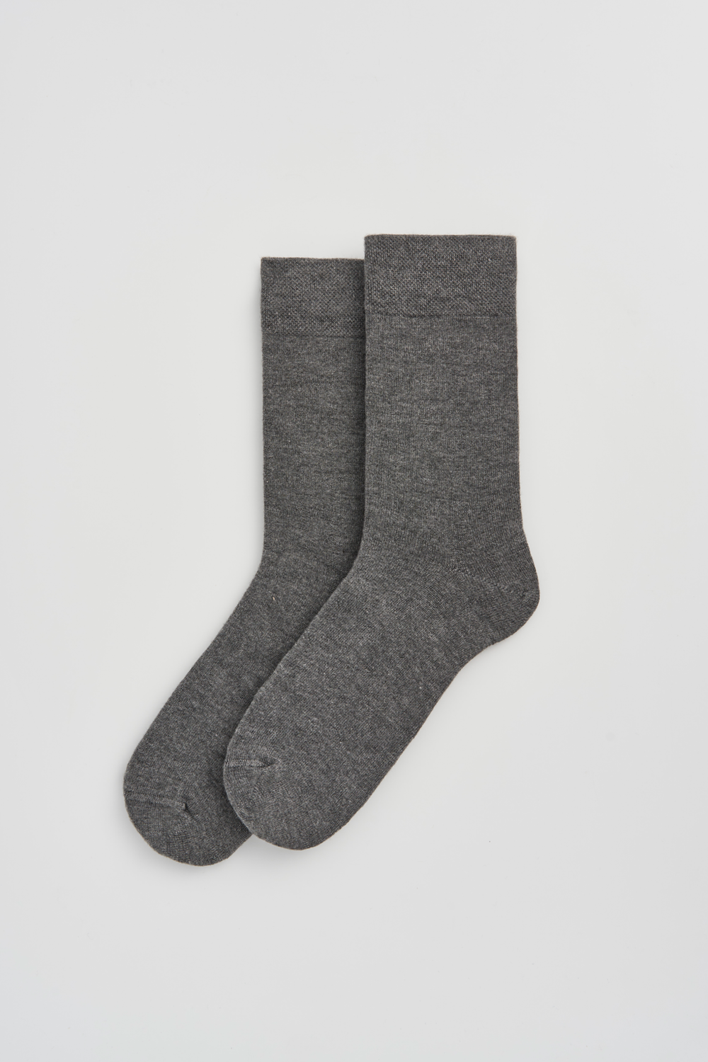 Pair of grey calf-length bamboo socks on a light grey background