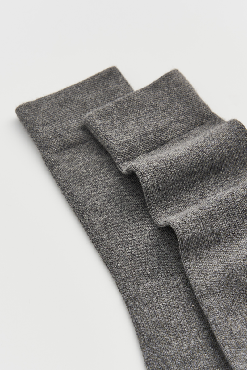 Close-up of a pair of calf-length bamboo socks on a light grey background