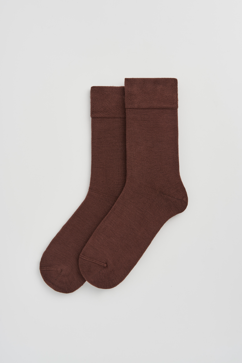 Pair of brown calf-length bamboo socks  on a light grey background