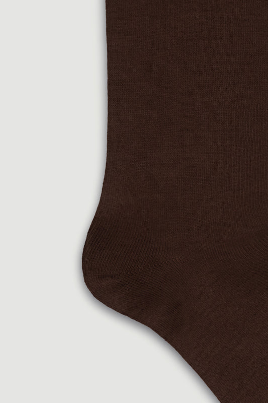 Close-up of the heel of a brown bamboo calf length sock on a white background