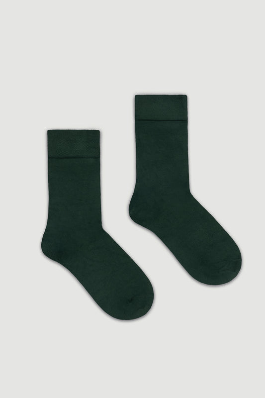 Pair of dark green calf length bamboo socks on a white background