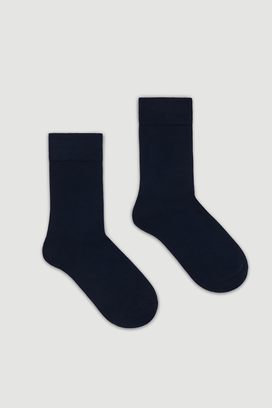Pair of navy blue calf length bamboo socks on a white background