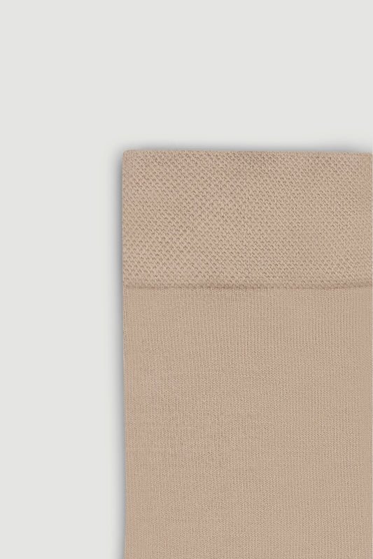 Close-up of the top of a beige bamboo calf length sock