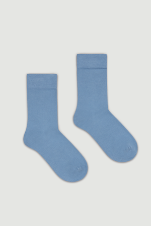 Pair of light blue bamboo calf length socks on a white background