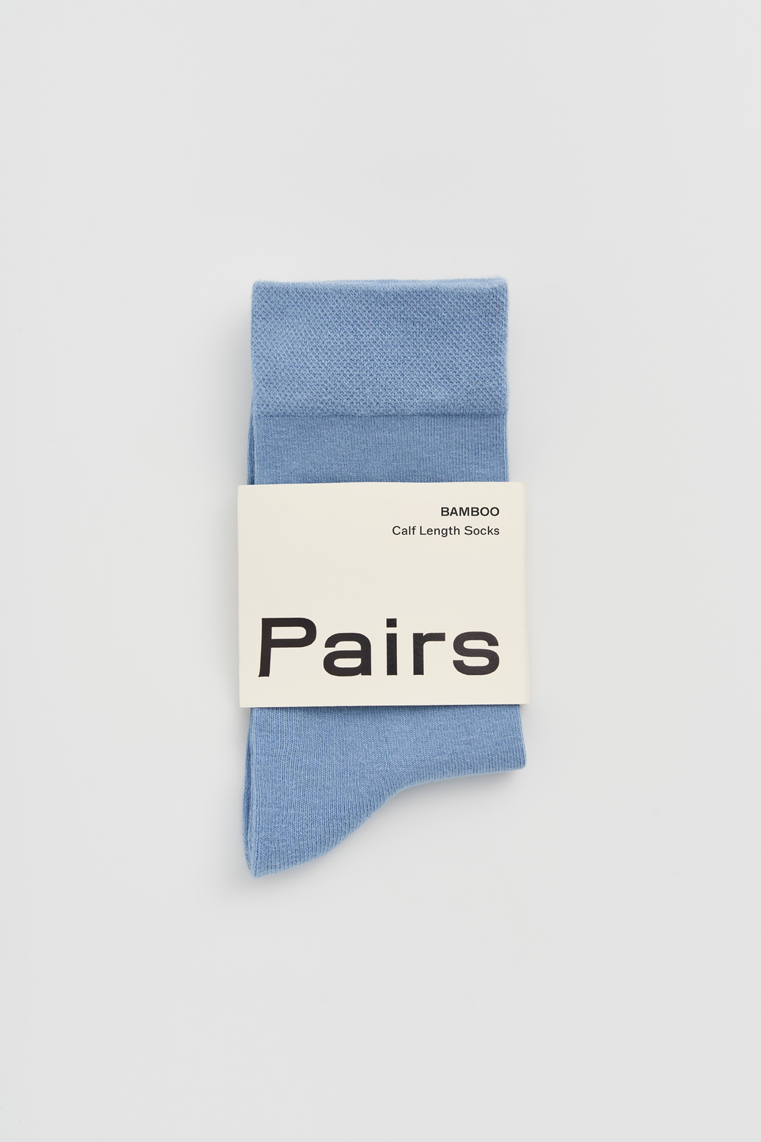 Blue calf-length bamboo sock with a 'Pairs' packaging band on a light grey background