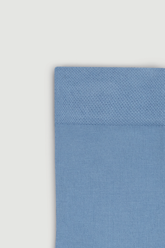 Close-up of the top of a light blue bamboo calf length socks on a white background