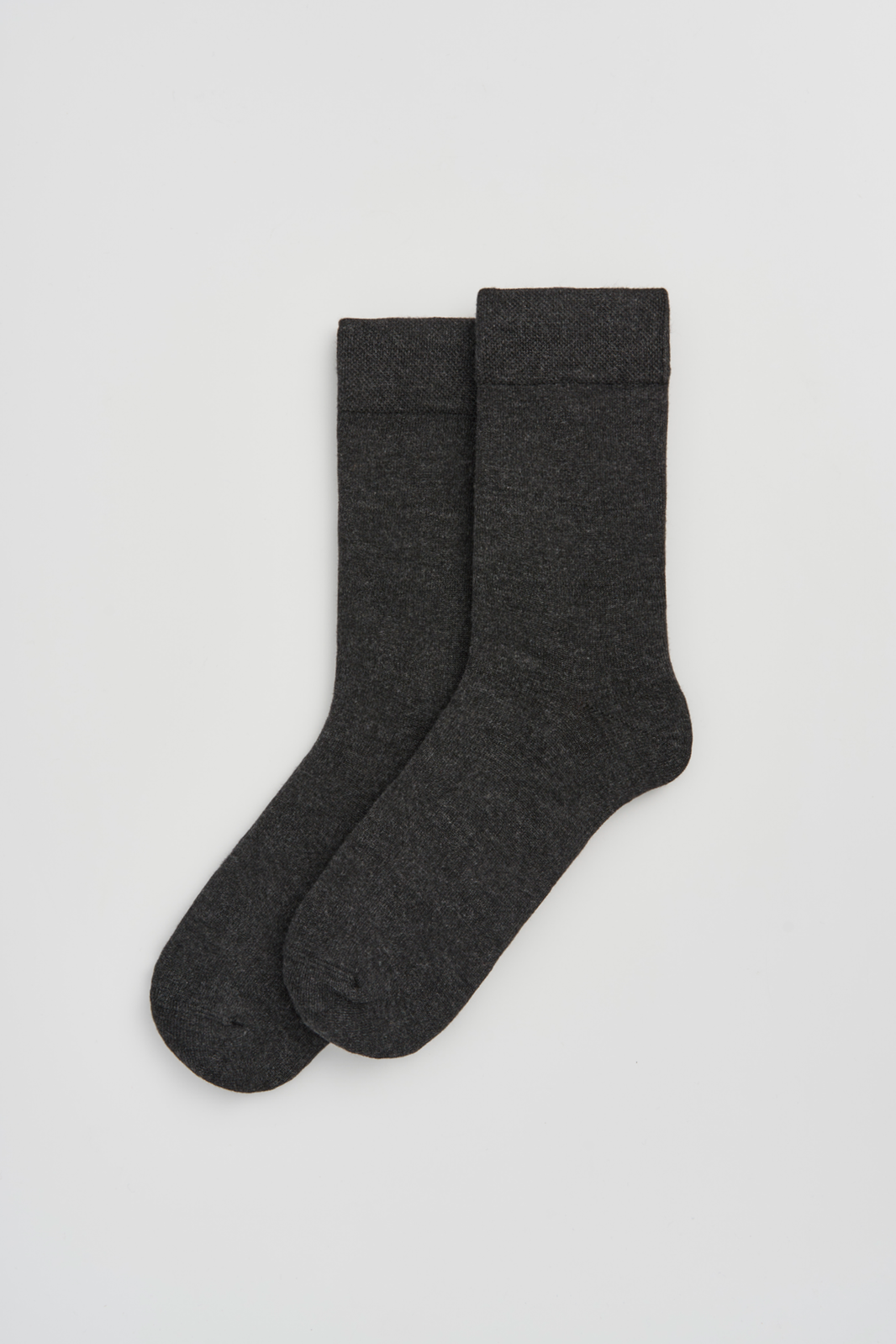 Pair of dark grey calf-length bamboo socks on a light grey background