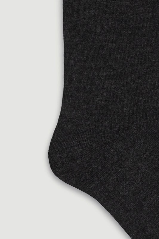 Close-up of the heel of a dark grey bamboo calf length sock on a white background