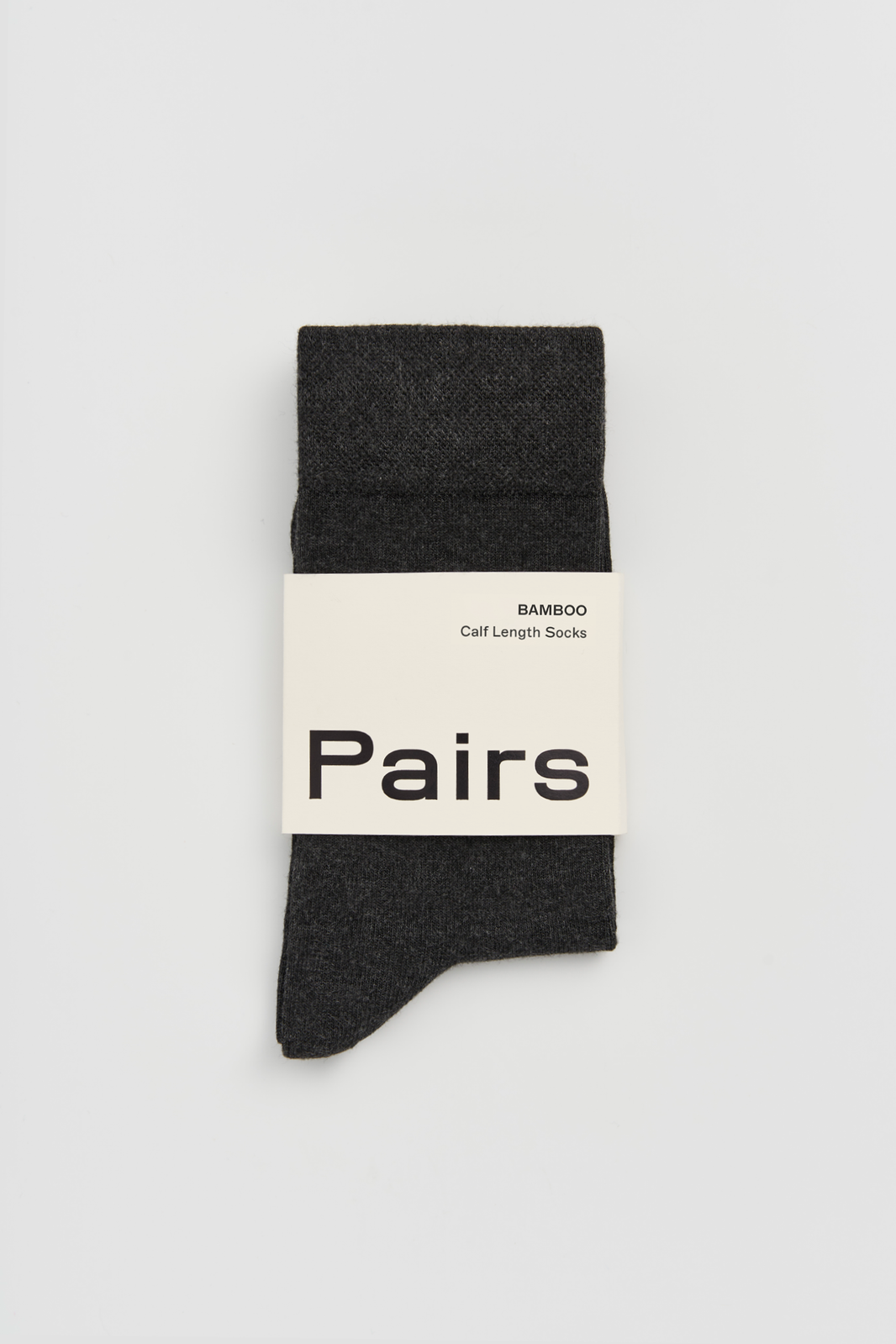 Dark grey calf-length bamboo sock with a 'Pairs' packaging band on a light grey background