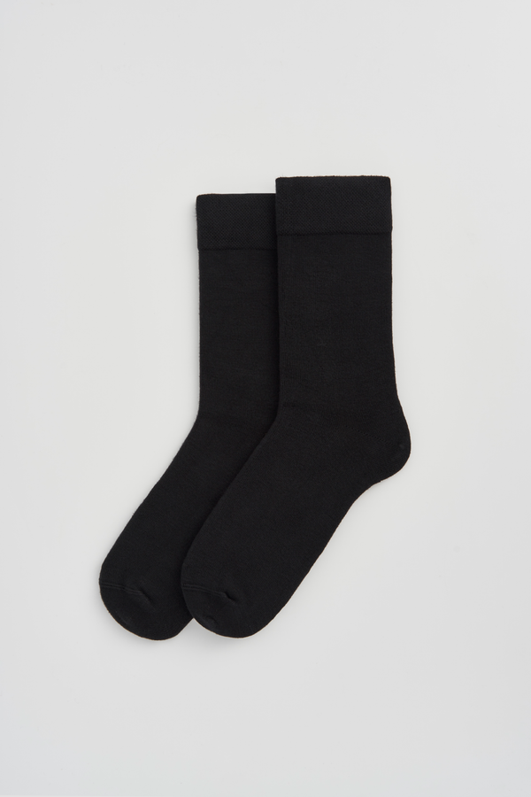 Pair of black calf-length bamboo socks  on a light grey background