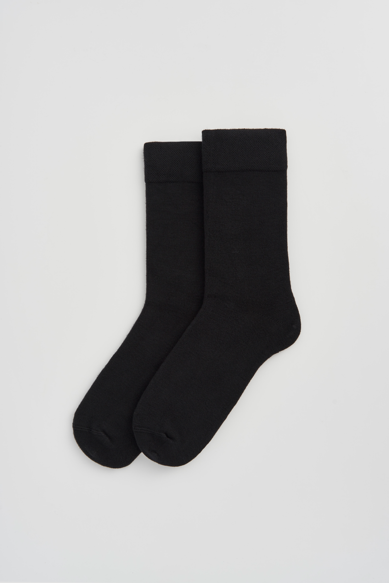 Pair of black calf-length bamboo socks  on a light grey background