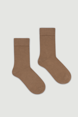 Pair of light brown bamboo calf length socks on a light grey background