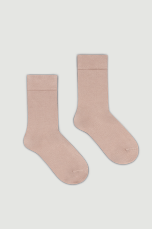 Pair of light pink bamboo calf length socks on a white background