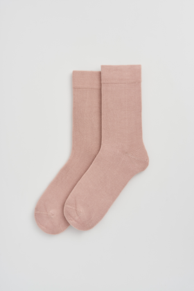 Pair of pink calf-length bamboo socks on a light grey background