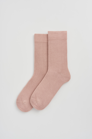 Pair of pink calf-length bamboo socks on a light grey background