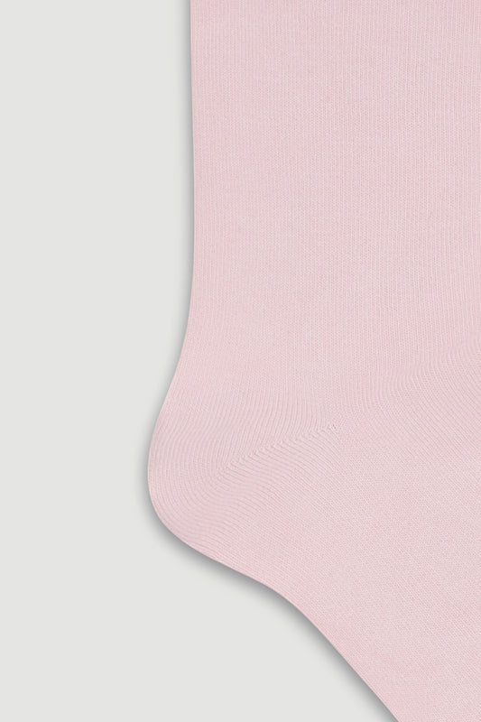 Close-up of the heel of a light pink bamboo calf length socks on a white background