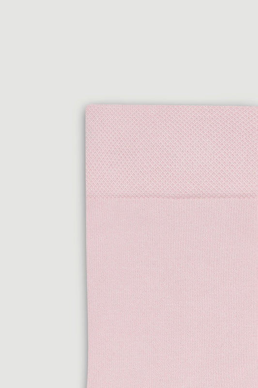 Close-up of the top of a light pink bamboo calf length sock on a white background