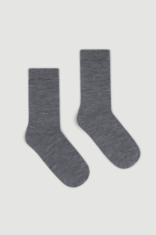 Pair of grey merino calf length socks on a white background