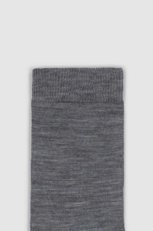 Close-up of the top of a mid-grey calf length merino sock on a white background