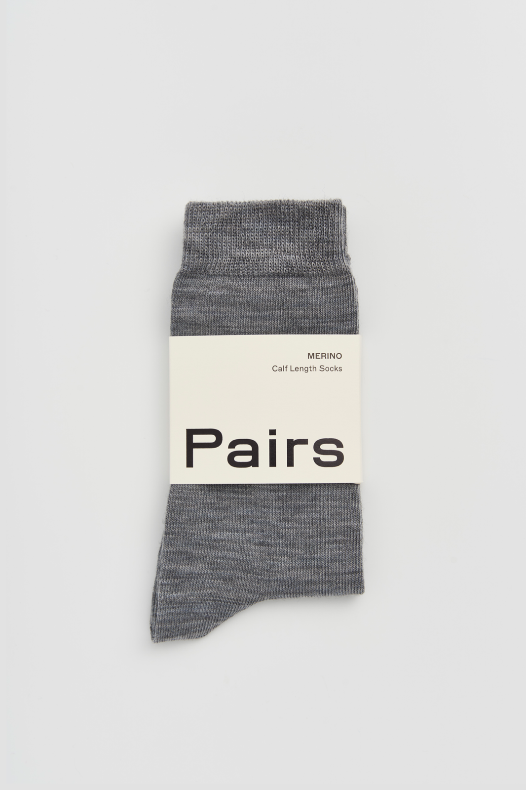 Grey calf-length merino sock with a 'Pairs' packaging band on a light grey background