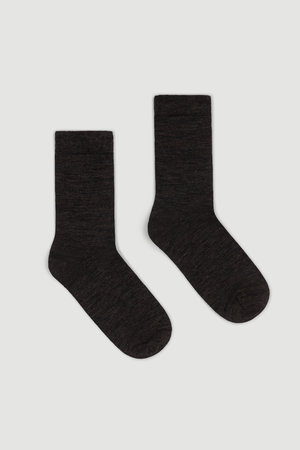 Pair of dark brown calf length merino socks on a white background