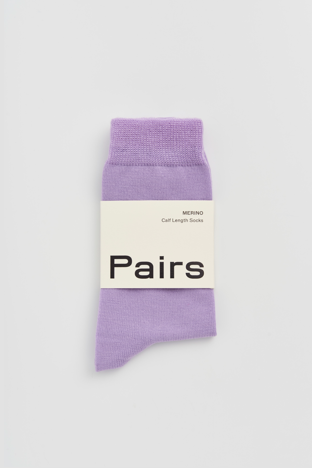Lilac calf-length merino sock with a 'Pairs' packaging band on a light grey background