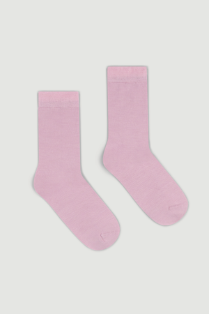 Pair of light pink calf length merino socks on a white background