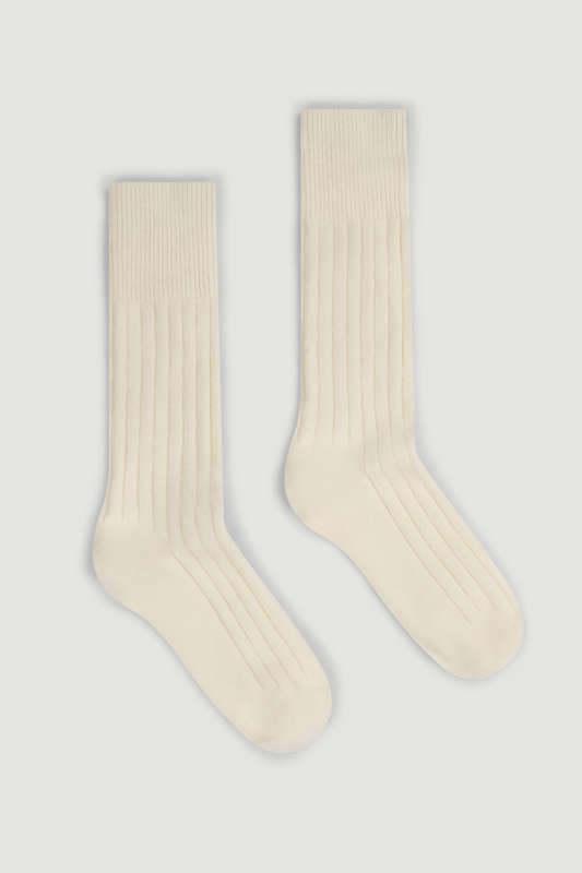 Pair of cream merino ribbed bed socks on a white background