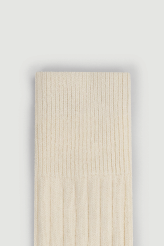 Close-up of the top of a cream merino ribbed bed sock