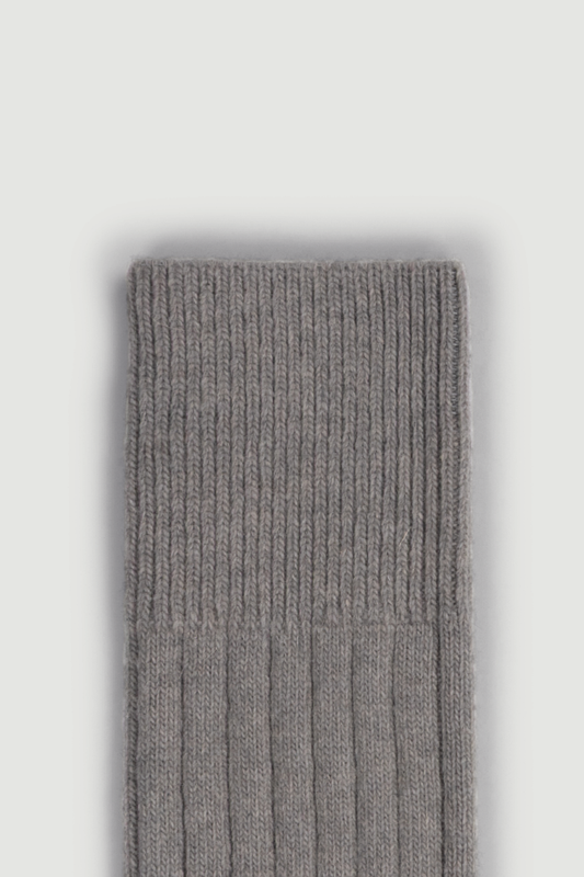 Close-up of the top of a merino ribbed bed sock on a white background