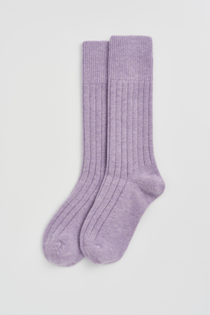 Pair of lilac merino ribbed bed socks on a light grey background