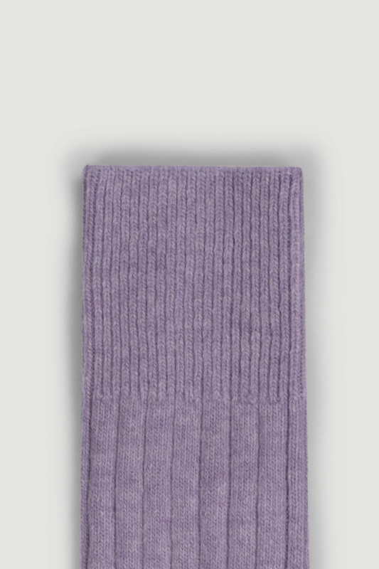 Close-up of the top of a lilac merino ribbed bed sock on a white background