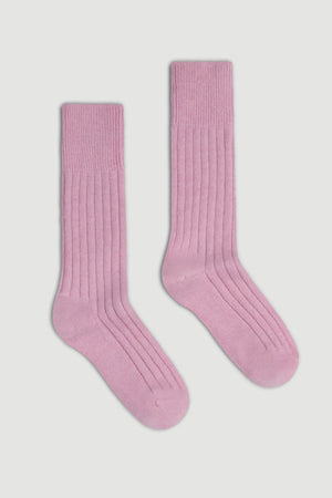 Pair of pink merino ribbed bed socks on a white background