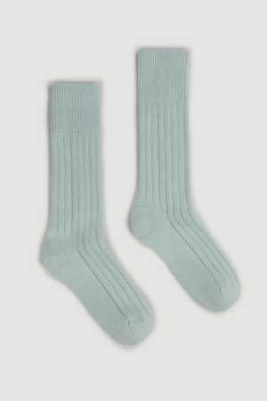 Pair of pale minty green merino ribbed bed socks on a white background
