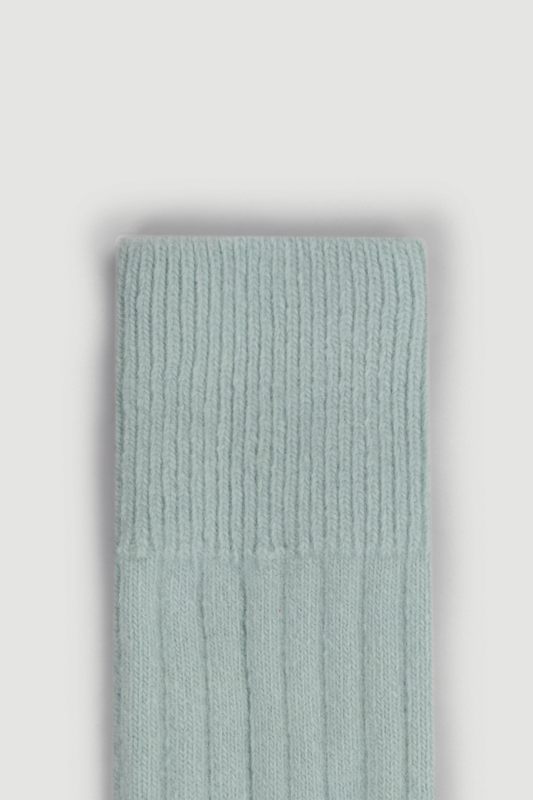 Close-up of the top of a merino ribbed bed sock on a white background