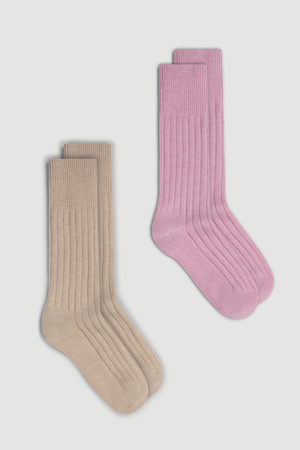 Two pairs of merino ribbed bed socks, one beige and one pink, on a white background.